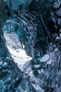 Ice cave open to the top with snow-covered ice combs, Pröng ice cave, Sudurland, Iceland