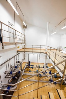 Industrial interior staircase with surrounding stainless steel pipes, ENCW Netze Calw waterworks,