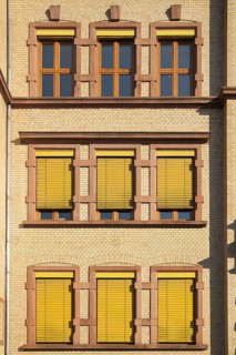 Yellow house wall with window, roller shutter, blind at the Robert Koch School, house wall, facade,