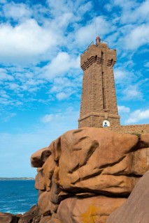 Stony lighthouse rises above the rocks under a clear sky, Phare de Men Ruz, Ploumanac'h,