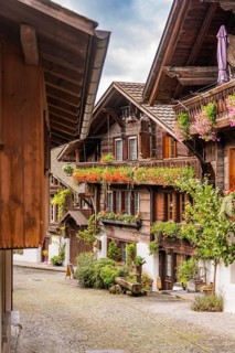Picturesque alley with half-timbered houses and balconies decorated with flowers, Lake Brienz,