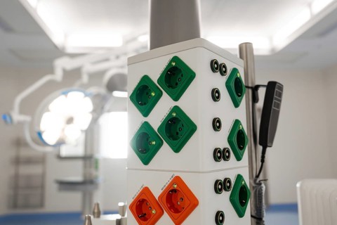 White walls with colorful sockets and medical devices in one room, operating room in the new Calw