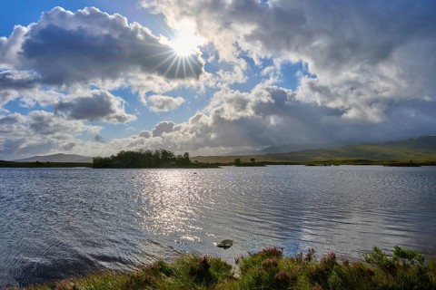 Tranquil landscape with a sunny, partly cloudy sky over a lake, Rannoch Moor, Bridge of Orchy,