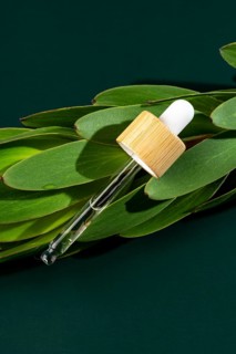 Transparent micellar water for face care displayed in a minimalist pipette bottle, resting on