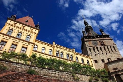 Romania, hour tower and cultural house in the historic old town of Sighisoara, German Sighisoara,