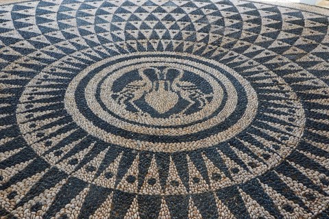 Artistic mosaic of pebbles with geometric patterns in a large circle, Kalithea, Kallithea, thermal