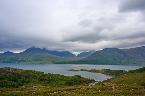 View of a lake with surrounding mountains under heavily cloudy sky, Loch Torridon, Kenmore,