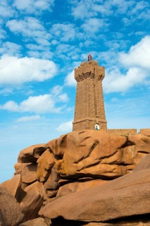 A lighthouse perched on massive rocks under a blue sky, Phare de Men Ruz, Ploumanac'h, Ploumanach,