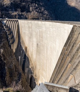 Aerial shot of the iconic Contra Dam in the Verzasca Valley, set within the picturesque Locarno