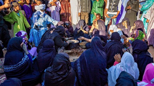 People in traditional dress at a cultural gathering, lively and communal, Traditional woman play