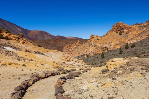 Mountain hiking on Montana Guajara, Canada del Capricho rock formation, Teide National Park,