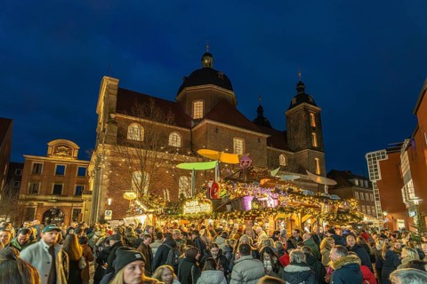Christmas market at the Dominican Church at dusk, Münster, North Rhine-Westphalia, Germany