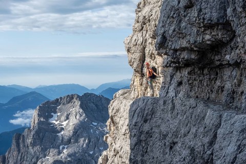 Climbers on a rock band, Bocchette Centrale band trail, via ferrata in the Brenta Mountains,