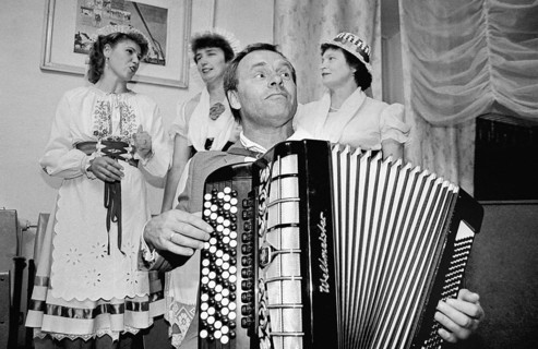 Musicians from the Russian-German music group Lebenslust play German folk songs in a village in