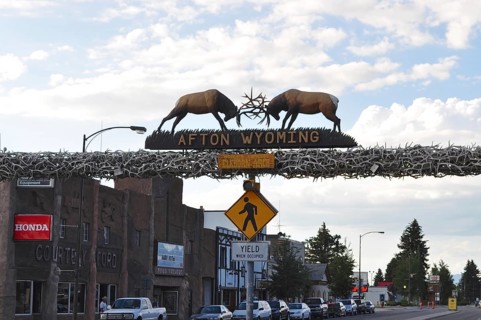 An arch with a deer sculpture straddles a road in Afton, Wyoming, Wyoming, USA