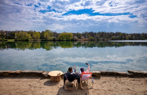 Couple, couple enjoying free time, young man and young woman, on deckchairs, sandy beach, shore,