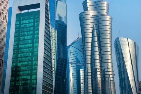 Modern glass fronted high rise skyscrapers and office towers of the financial district line the