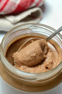 Almond cream in jar with spoon, almond spread