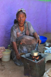 In the highlands of Abyssinia, in the village of Sina, young woman roasting coffee for the coffee