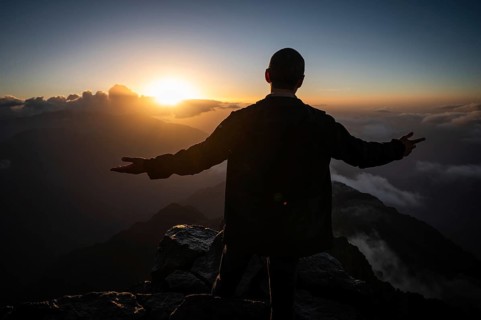 Man on the peak Toubkal, the highest mountain in North Africa during sunrise