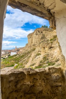 Breathtaking view of arguedas village and its cave houses carved into the sandstone cliffs, seen
