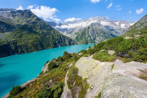 Turquoise blue mountain lake Göscheneralpsee, picturesque mountain landscape with dammastock and