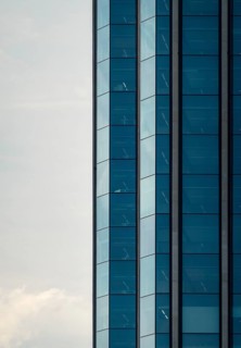 Close-up of a contemporary skyscraper featuring a blue glass facade, located in Colon City, Panama.