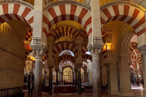 Columns and arches with red stripes in the cathedral mosque of Córdoba (Mezquita-Catedral),