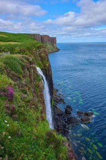 Breathtaking view of cliffs and seaside waterfall under a cloudy sky, Kilt Rock Waterfall, Portree,