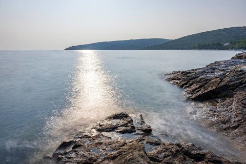 Crystal clear and turquoise water on the beach of Ustrine Bay on a sunny day on the island of Cres,