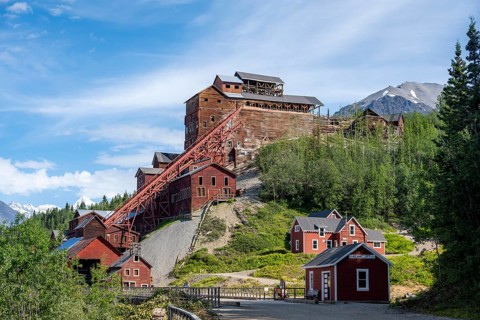 Red Kennicott buildings in front of mountainous landscape, Kennicott Concentration Mill to extract