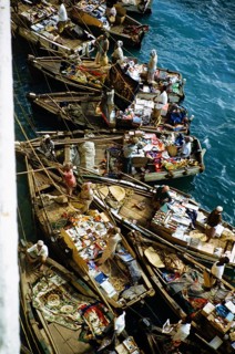 Small open boats in which merchants sell souvenirs and products to the passengers of a ship, Aden,