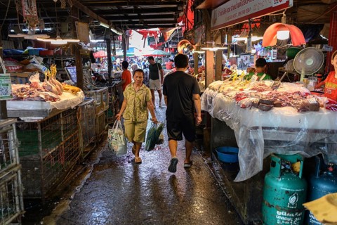 Bangkok, Thailand. February 19th 2025. A Local Thai woman shopping at the Khlong Toei Market,