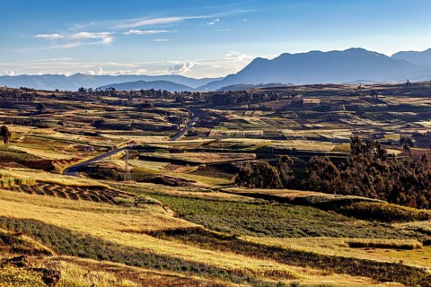 Extensive landscape with fields and hills under a clear sky, The landscape in the Sacred Valley of