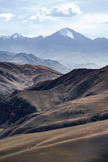 View over eroded mountainous landscape with brown hills, mountains and steppe, Chuy province,