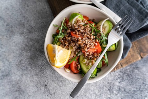 A nutritious and colorful dish of fresh rocket, oregano, cherry tomatoes, cucumber, Himalayan salt,