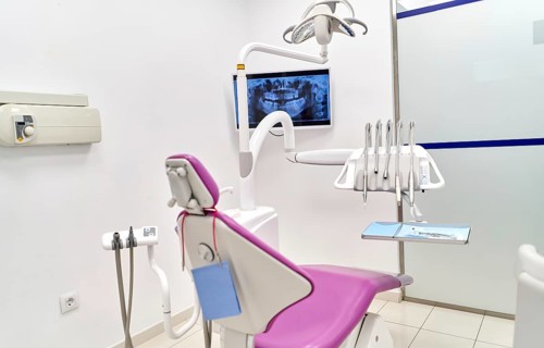 A modern dental clinic showcasing state-of-the-art equipment, including a dental chair, various