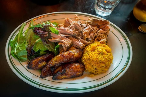 Vibrant plate showcasing a delicious and satisfying caribbean inspired meal, featuring tender