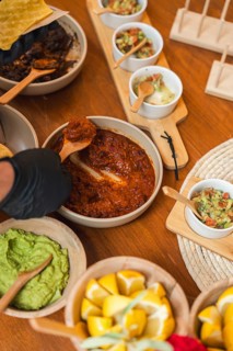 A rich and hearty spread featuring Mexican tacos with assorted fillings and vibrant toppings. The