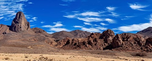 Panoramic picture of a dry desert landscape with rocky mountain and blue sky, The landscape of the