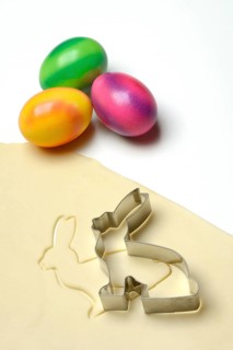 Rolled dough with bunny cookie cutter and easter eggs