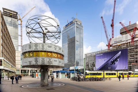 View of Alexanderplatz in Berlin. Covivio Tower construction site. Landmark world clock. Behind it,
