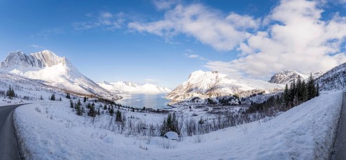A breathtaking snowy mountain landscape of Mefjordbotn, Norway, showcasing serene snow-covered