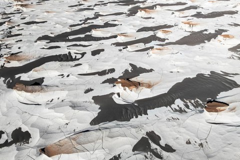 This aerial view captures the unique pumice field in Catamarca, Argentina. The striking contrast of