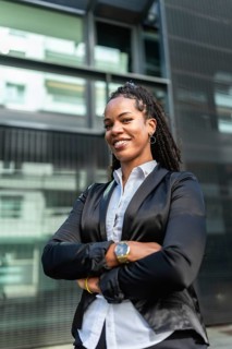 Vertical portrait photo with copy space of a latin female trader standing smiling at camera