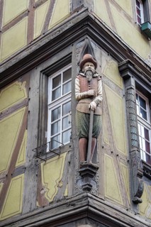 Wooden figure at the historic Maison Zum Kragen in the Rue des Marchands, Colmar, Alsace, France