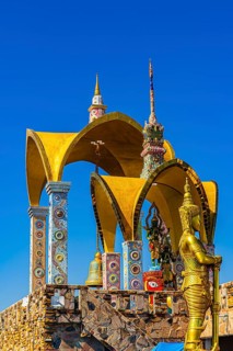 Round arch pavilions decorated with colorful mosaics and glass works of art, in front of a gilded