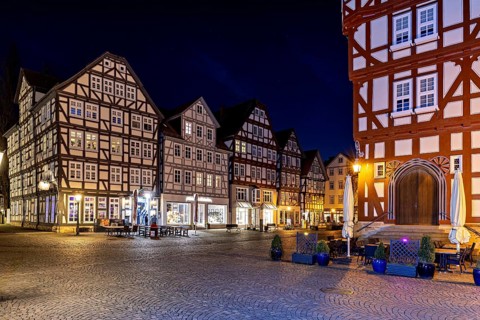 Historic half-timbered houses at night with illuminated streets and a cosy atmosphere, the old town