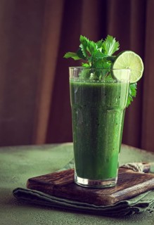 Glass with green smoothie, celery and spinach, apple and kiwi, cucumber, vegetable smoothie,