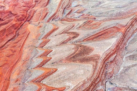 Striking aerial photograph showcasing the intricate, colorful sandstone formations along the San